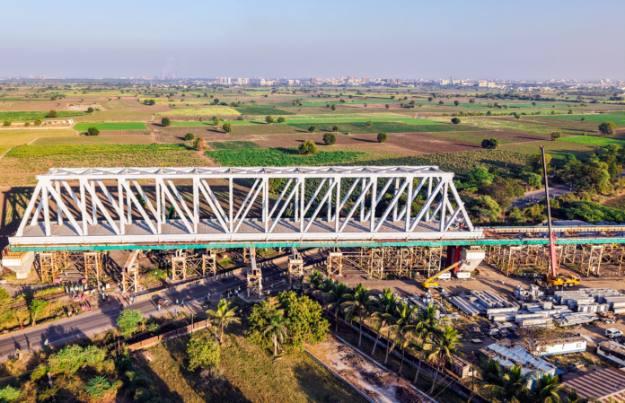 130 m span of a 230 m long steel bridge launched over NH-64 & Indian Railway tracks for Bullet Train Project_02_0 130m Span Launched over National Highway-64 in Gujarat for Bullet Train Project